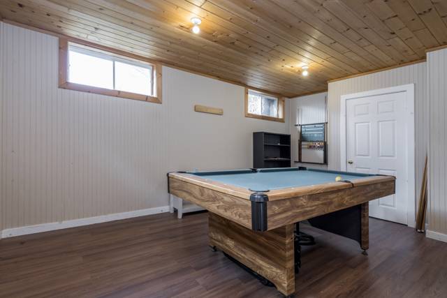 Rec room: Pool table room with pine plank ceiling